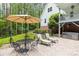 Relaxing backyard with a wrought iron table and chairs, lounge chairs, mature trees, and a hot tub at 1956 Forest Ridge Dr, Stanley, NC 28164