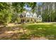 Beautiful home with a charming front porch is nestled on a sprawling lot with mature trees at 1956 Forest Ridge Dr, Stanley, NC 28164