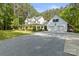 Beautiful two-story home with a detached two-car garage, complemented by a gravel driveway at 1956 Forest Ridge Dr, Stanley, NC 28164