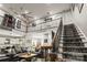 Open-concept living room boasts high ceilings, a staircase, and farmhouse decor at 1956 Forest Ridge Dr, Stanley, NC 28164