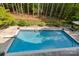 Overhead view of a sparkling backyard pool with lush greenery and a privacy fence at 1956 Forest Ridge Dr, Stanley, NC 28164