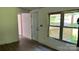 Living room area featuring new wood floors, a white door, and a window overlooking the front porch at 2131 Barnett St, Lancaster, SC 29720