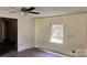 Partially renovated living room featuring new wood floors, a ceiling fan, and ample natural light at 2131 Barnett St, Lancaster, SC 29720