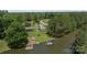 Aerial view of a waterfront property with multiple structures and mature trees at 281 Emerald Shores Rd, Mount Gilead, NC 27306