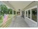 Covered back porch with ample space for relaxing and enjoying the outdoor view at 281 Emerald Shores Rd, Mount Gilead, NC 27306