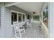 Inviting back porch with rocking chairs overlooking the lush yard and beautiful scenery at 281 Emerald Shores Rd, Mount Gilead, NC 27306