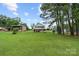 Large, green backyard with a two-story home featuring a walkout basement at 281 Emerald Shores Rd, Mount Gilead, NC 27306