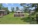 Spacious backyard with a two-story home featuring a walkout basement and deck at 281 Emerald Shores Rd, Mount Gilead, NC 27306
