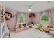 Playful ' bedroom with pink walls, plush toys, and natural light streaming in from windows at 281 Emerald Shores Rd, Mount Gilead, NC 27306