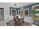 Charming dining room featuring a wood table and large windows overlooking a serene outdoor view at 281 Emerald Shores Rd, Mount Gilead, NC 27306