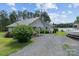 Charming waterfront home featuring a carport and gravel driveway at 281 Emerald Shores Rd, Mount Gilead, NC 27306