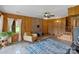 Inviting living room with wood paneling, brick fireplace, and plenty of natural light at 281 Emerald Shores Rd, Mount Gilead, NC 27306