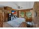 Cozy living room with wood paneling, brick fireplace, and sliding glass doors to outdoor space at 281 Emerald Shores Rd, Mount Gilead, NC 27306