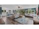 Inviting living room featuring stylish furniture, large windows overlooking the lake, and a modern ceiling fan at 281 Emerald Shores Rd, Mount Gilead, NC 27306