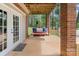 Relaxing patio with a swing, overlooking scenic views of the surrounding trees and lake at 281 Emerald Shores Rd, Mount Gilead, NC 27306