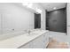 Modern bathroom with double vanity, quartz countertop, sleek fixtures, and a stylish black tiled shower over tub at 2813 New Pineola Rd, Charlotte, NC 28208