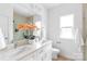 Bright bathroom features a double sink vanity with a large mirror, a window, and a glass shower enclosure at 2813 New Pineola Rd, Charlotte, NC 28208