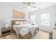Cozy bedroom features neutral decor, a ceiling fan, two windows and a wooden bed frame with bedside tables at 2813 New Pineola Rd, Charlotte, NC 28208