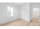 A light filled room shows a window, double door closet, and light wood floors at 2813 New Pineola Rd, Charlotte, NC 28208