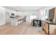 Bright dining area with an open kitchen concept, complete with a center island and modern bar stools at 2813 New Pineola Rd, Charlotte, NC 28208