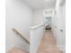 Bright upstairs hallway with hardwood floors and a staircase leading to the lower level at 2813 New Pineola Rd, Charlotte, NC 28208