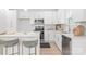 Modern kitchen features stainless appliances, white cabinets, an island with seating, and light wood flooring at 2813 New Pineola Rd, Charlotte, NC 28208