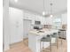 Well-lit kitchen featuring white cabinetry, a center island with bar seating, and modern appliances for a functional cooking space at 2813 New Pineola Rd, Charlotte, NC 28208