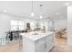 Open concept floor plan boasts light wood floors, an island with seating, a dining area, and a living space at 2813 New Pineola Rd, Charlotte, NC 28208