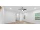 Bright bedroom featuring a ceiling fan, a large window, and ample closet space at 2815 New Pineola Rd, Charlotte, NC 28208