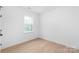 Bright bedroom with neutral walls, a large window, and stylish flooring at 2815 New Pineola Rd, Charlotte, NC 28208