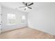 Well-lit bedroom with ceiling fan and large windows, providing ample natural light and ventilation at 2815 New Pineola Rd, Charlotte, NC 28208