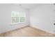 Bright bedroom with neutral walls, a large window, and stylish flooring at 2815 New Pineola Rd, Charlotte, NC 28208