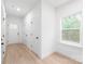 Bright entryway featuring hardwood floors, neutral paint, and ample natural light from a window at 2815 New Pineola Rd, Charlotte, NC 28208