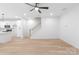 Living room with hardwood floors, modern lighting, white walls, and a staircase at 2815 New Pineola Rd, Charlotte, NC 28208