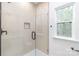 The glass walk-in shower showcases a beautifully tiled accent wall, adding a touch of luxury at 2815 New Pineola Rd, Charlotte, NC 28208