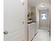Clean laundry room with modern washer and dryer on tiled floors and a storage shelf at 3015 Great Falls Hwy, Chester, SC 29014