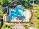 An aerial view features a swimming pool area surrounded by lounge chairs and manicured landscaping at 3103 Oliver Stanley Trl, Lancaster, SC 29720