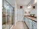 Bright bathroom featuring a glass-enclosed shower and double vanity with modern fixtures and neutral finishes at 3103 Oliver Stanley Trl, Lancaster, SC 29720