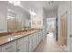 Bright bathroom with a double vanity, large mirror, and a glass-enclosed shower, offering a clean, modern aesthetic at 3103 Oliver Stanley Trl, Lancaster, SC 29720