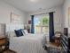 Inviting bedroom featuring a comfortable bed with nautical decor, natural light, and views of the outdoors at 3103 Oliver Stanley Trl, Lancaster, SC 29720