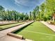 Community bocce ball court featuring an artificial turf surface and convenient seating for players at 3103 Oliver Stanley Trl, Lancaster, SC 29720