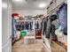 Walk-in closet with ample storage space, featuring wooden floors and well-organized hanging racks and shelves at 3103 Oliver Stanley Trl, Lancaster, SC 29720