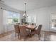 Well-lit dining room features modern light fixtures and a large window, ideal for entertaining at 3103 Oliver Stanley Trl, Lancaster, SC 29720