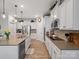 Open kitchen featuring stainless steel appliances, light countertops, and sleek white cabinets at 3103 Oliver Stanley Trl, Lancaster, SC 29720