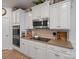 Kitchen detail showcasing stainless steel appliances, white cabinets, and stylish decor at 3103 Oliver Stanley Trl, Lancaster, SC 29720
