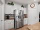 Kitchen detail featuring a stainless steel refrigerator, white cabinets, and modern fixtures at 3103 Oliver Stanley Trl, Lancaster, SC 29720