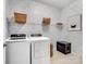 A well-organized laundry room with modern appliances, storage shelves, and a litter box at 3103 Oliver Stanley Trl, Lancaster, SC 29720