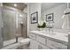 Bright bathroom featuring a glass shower, white vanity, and stylish decorative accents at 3128 Stelfox St, Charlotte, NC 28262