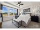 Light-filled bedroom featuring a tray ceiling, large windows, and modern accents at 3128 Stelfox St, Charlotte, NC 28262