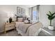 Well-lit bedroom featuring neutral tones, soft textures, stylish decor, and a comfortable bed setting at 3128 Stelfox St, Charlotte, NC 28262